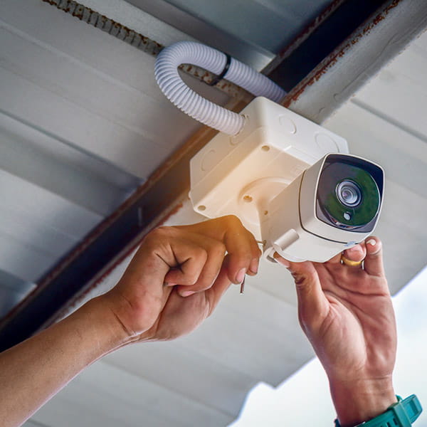 security camera mounted outdoors on ceiling